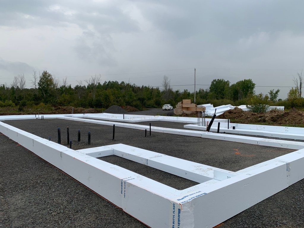 Image of plumbing rough-ins and foam perimeter for raft slab foundation