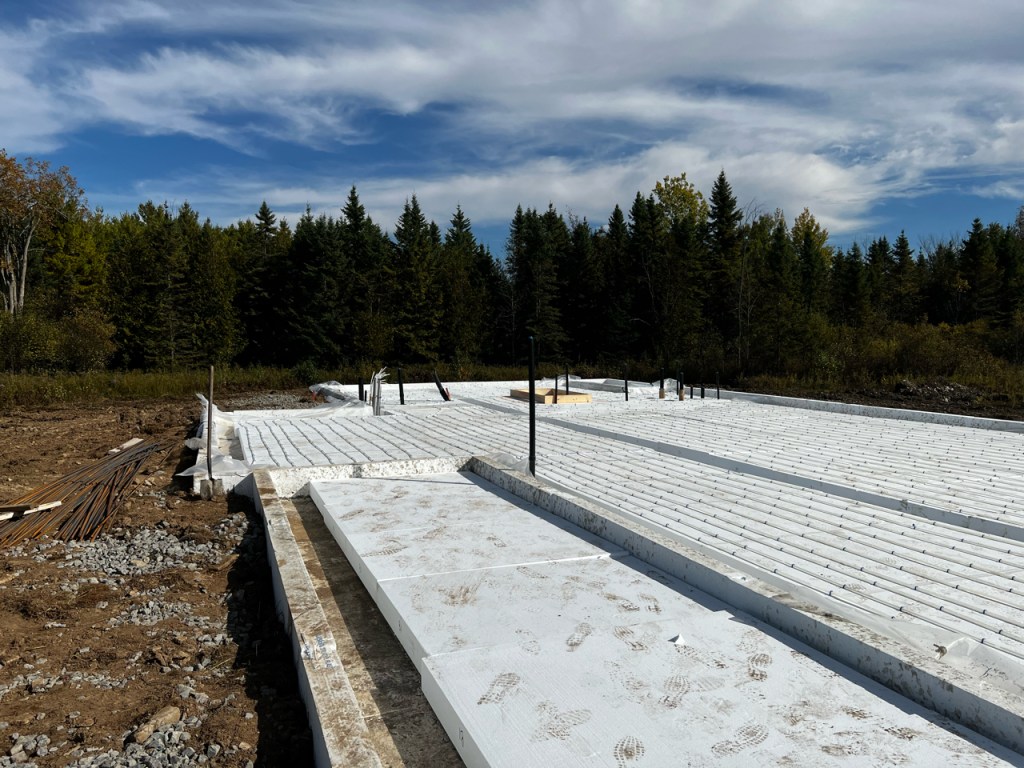 Image of foam foundation with tubing for radiant in-floor heat laid on top.