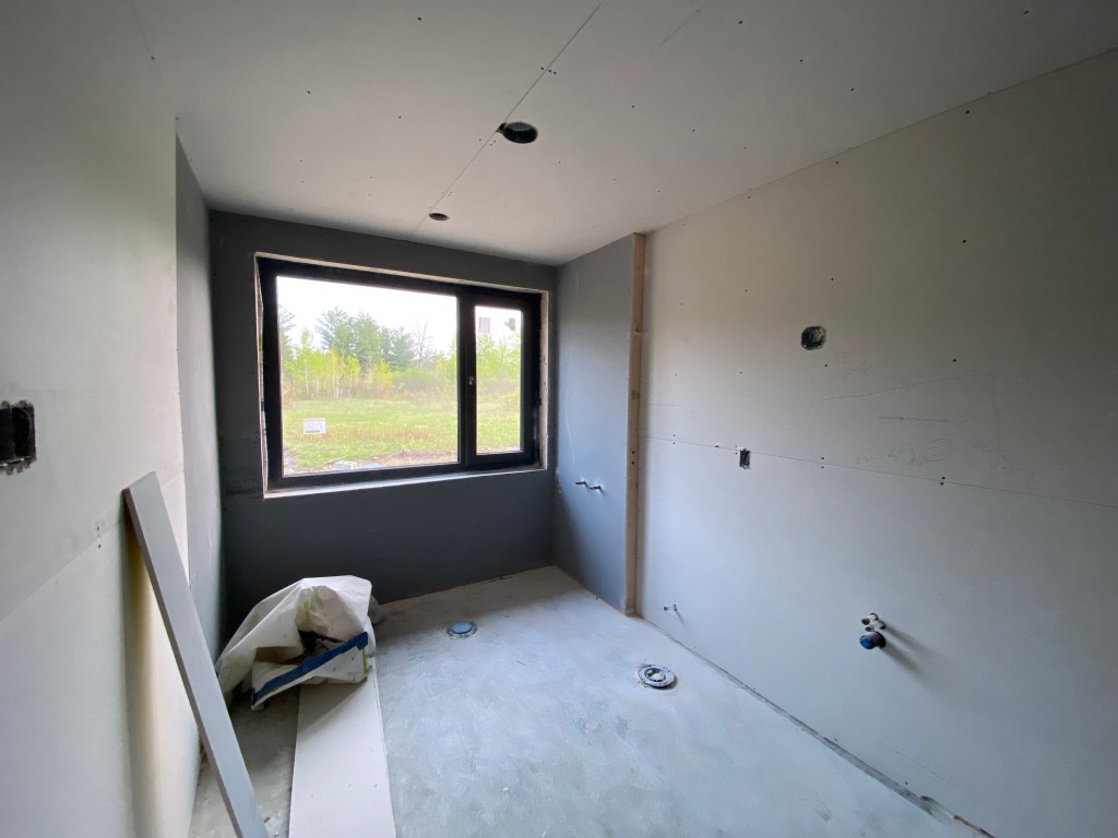 Image of house under construction with drywall installed in bathroom