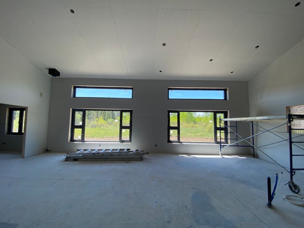 Image of house under construction with drywall boards installed in living room