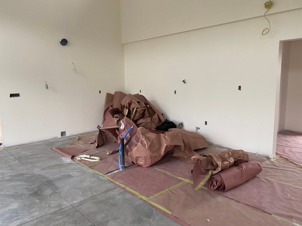 Picture of protective paper being taken off floor