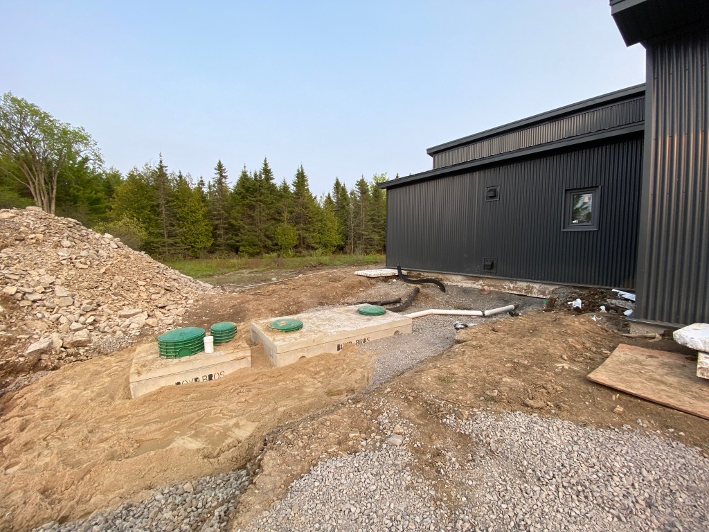 Picture of septic tank and dosing chamber next to house